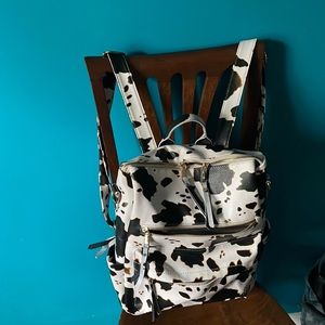 Cow print leather back pack bag .